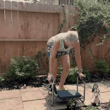 Kneeling down onto the padded kneeler in a garden bed